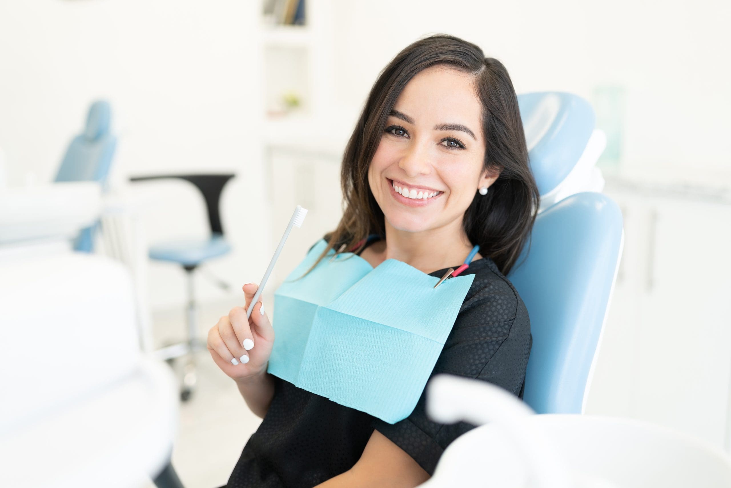 attractive-patient-sitting-on-chair-during-checkup